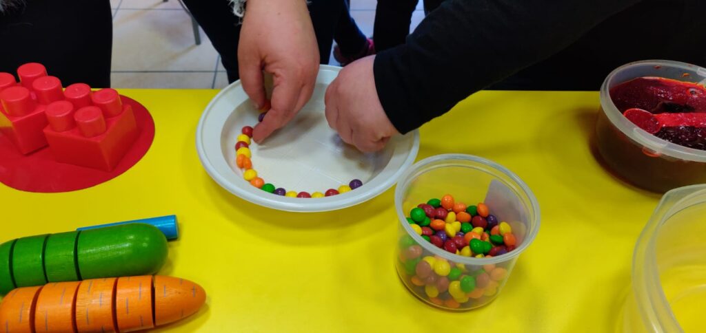 image of students placing candies in a plate.