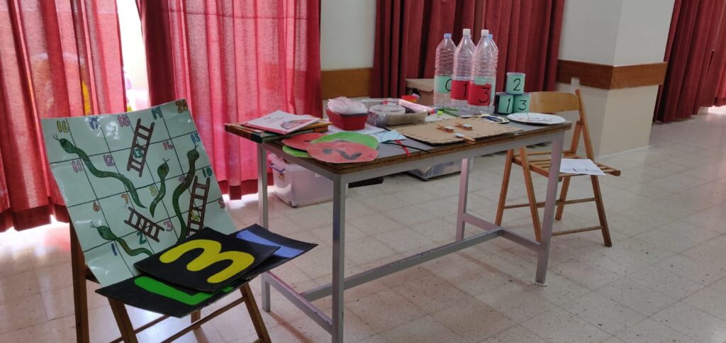 image of a chair with a painting on it and a table with crafts items