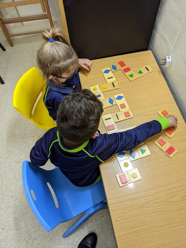 Children playing with Shape dominoes