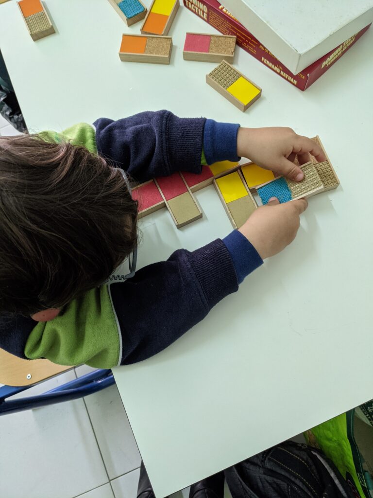 Child playing with Texture dominoes